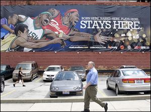 Cleveland fans funded a banner near Quicken Loans Arena to show their thoughts about what LeBron James should do.