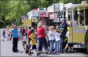 Bedford Township firefighter and EMT Phil Dale shows Engine 5 to students at the Bedford Public Schools Safety Vehicle Expo.