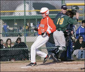 SPT clayview31p      03/30/2010       The Blade/Lori King  Southview's Todd Vandercook scores against Clay's catcher Austin Petroff during game at Clay HS in Oregon, OH.  