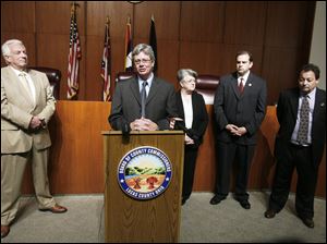 Lucas County Commissioner Pete Gerken, at podium, presents his government reform plan with, from left, county Democratic Party Chairman Ron Rothenbuhler, Recorder Jeanine Perry, Treasurer Wade Kapszukiewicz, and Clerk of Courts Bernie Quilter. 