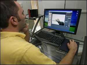 Zack Ward photographs the tortoises in the TechTol studio. The firm received a $50,000 development grant two years ago. 