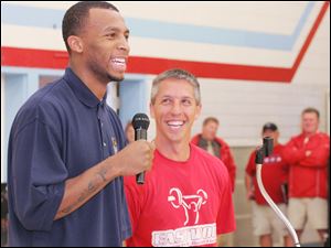 Former Ohio State basketball player and current member of the Miami Heat Daequan Cook presents Eastwood's Brian Sabo with a milk campaign award.