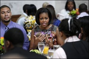 First lady Michelle Obama talks with students at a White House youth leadership and mentoring luncheon at the Detroit Institute of Arts in Detroit, Wednesday.