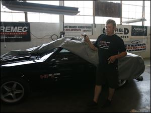 Doug Pelmear of Napoleon shows off his second Mustang that he converted into a vehicle that can get 110 miles per gallon. The V-8 engine runs on E85 fuel and produces 400 horsepower.