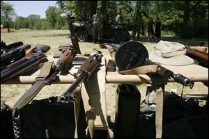 The weapons are a mix of authentics and replicas. Re-enactors often carry both in their collections of military gear. An authentic World War II automatic weapon can cost up to $40,000.