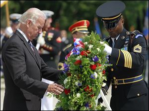 Vice President Joe Biden places a wreath at the Tomb of the Unknowns during a Memorial Day ceremony at Arlington National Cemetery. Mr. Biden represented President Obama. 