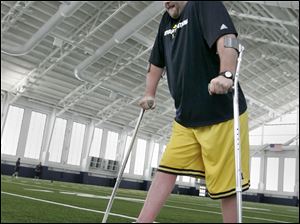 Brock Mealer of Wauseon, paralyzed from a car crash, is undergoing rehabilitation at the University of Michigan, where his brother, Elliott, is a football player. The crash killed their father.