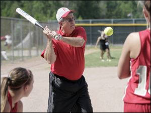Rick Schneider, Bedford High's softball coach, gives a batting tip. 