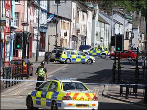 Police officers secure a shooting scene in Whitehaven, in northwest England, one of 30 crime scenes in a deadly shooting spree yesterday by taxi driver Derrick Bird, who was 52.