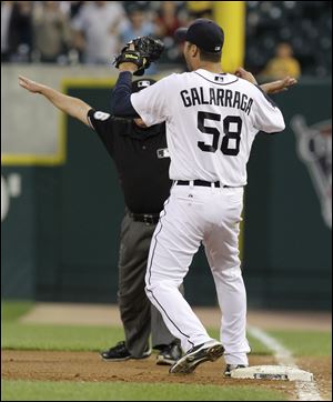 Tigers pitcher Armando Galarraga can't believe what he sees as umpire Jim Joyce signals safe at first base. Joyce is a Toledo native who graduated from Central Catholic.