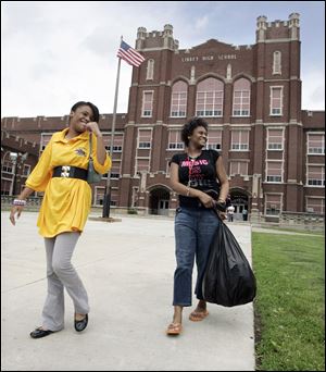 Na'Risa Washington, left, and her sister, Na-Reze, leave Libbey High School, which closes for good,  after taking their final exams yesterday. Na'Risa says she hopes to attend Bowsher next year.