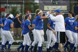 Emily Rockman is congratulated by Springfield coach Rob Gwozdz after hitting a home run against Clay in the district. Rockman leads the Blue Devils with a .441 batting average and 22 RBIs.