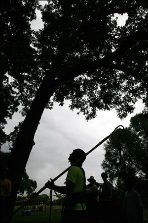 Jay Butcher prepares to climb a tree at Walbridge Park.
