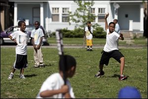 Juan Johnson, 13, pitches during a game at the Toledo Boys and Girls Clubs program at Sherman Elementary School.