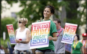 Delray Waddell carries a sign for an EqualityToledo event at Erie Street Market.
<br clear=all>
