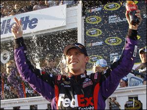 Denny Hamlin celebrates after winning his forth race this season. The victory also marks his fourth at Pocono, where he won twice in 2006 and again last year, shortly after of his grandmother's death. 