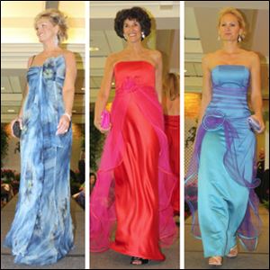 From left, Traci Schwann, Marla Osgood, and Cay Stout model gowns brought from Paris for the Toledo Opera Guild's fashion show.