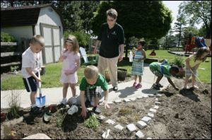 Sister Constance Marie Suchala, center, with students in the sensory garden at the Maria Early Learning Center.