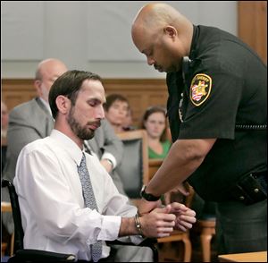 Ricky Miller Jr. is handcuffed in Lucas County Common Pleas Court in Toledo after being sentenced to 9 years in prison Thursday for aggravated vehicular homicide.
