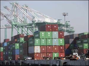 Containers sit dockside at the Port of Los Angeles. The Commerce Department says the U.S. trade deficit rose to the highest level in 16 months as exports fell for the second time in three months.
