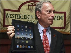 New York Mayor Michael Bloomberg, showing off his iPad, says he isn't troubled that his e-mail address was one of those exposed.