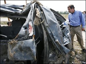 U.S. Sen. Sherrod Brown (D., Ohio) looks at the wreckage the tornado left behind. 