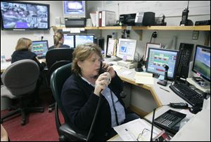 Lake Township dispatcher Faye Balsmeyer, foreground, works from the Northwood dispatch center. At rear are Northwood dispatch supervisor Amy Stribrny, left, and dispatcher Nicole Romstadt.