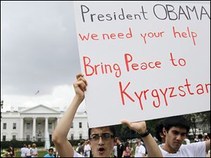 Faruk Eshankanov, 21, and Rustam Shadiev, 28, both of Kyrgyzstan, march outside the White House to raise awareness about the deadly clashes in their native land.