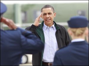 President Barack Obama returns a salute prior to boarding Air Force One en route to Gulfport, Miss., Monday as he embarks on a three-state tour of Gulf Coast affected by the BP Deepwater Horizon oil spill. 