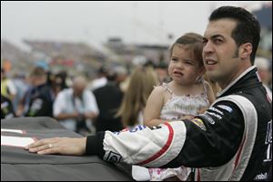 Defiance native Sam Hornish Jr. spends time with daughter Addison before the start of the race. Hornish led for five laps at the mid-point, but it went downhill from there. He finished 26th.