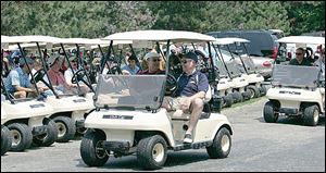 Golfers head to the first hole during the University of Toledo College of Medicine golf outing at Toledo Country Club.