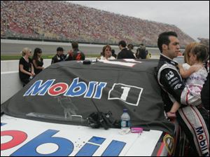 Sam Hornish Jr. holds his daughter, Addison Hornish, before the start of Sunday's race at MIS.