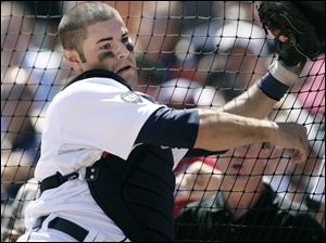 Tigers catcher Alex Avila falls against the backdrop after catching a foul ball hit by Washington's Josh Willingham Thursday.