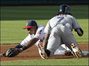 The Mets' Jose Reyes, right, dives back to second Thursday as the Tribe's Luis ValBuena bobbles a pickoff throw in the first inning.