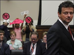 BP CEO Tony Hayward passes protesters to face the scrutiny of Congress. 