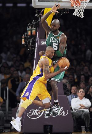 Kobe Bryant of the Lakers runs into Kevin Garnett of the Celtics in Thursday's Game 7 of the NBA Finals in Los Angeles. Bryant scored 23 points and was named NBA Finals MVP.
