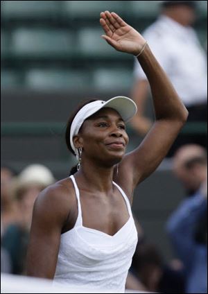 Venus Williams of the United States waves to the crowd after defeating Paraguay's Rossana De Los Rios Monday.