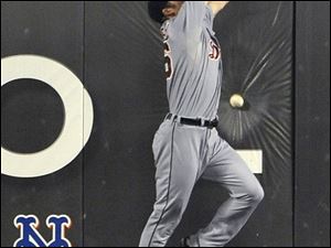 The Tigers' Brennan Boesch climbs the wall but can't come down with a drive hit by the Mets' Ike Davis that drove in a pair of runs in New York's eight-run third inning Tuesday night. 