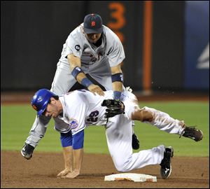 Tigers second-baseman Carlos Guillen tumbles over Mets Ike Davis after forcing out Davis in the 6th inning of the game at the Gotham City.