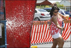 Kelly Robertson of Orgon ducks a splash from the dunking tank at the Oregon benefit event for tornado victims.