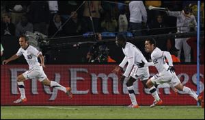 Landon Donovan, left, celebrates after scoring the go-ahead goal with fellow team members Benny Feilhaber, right, and Edson Buddle, second from right, during the World Cup group C match against Algeria.