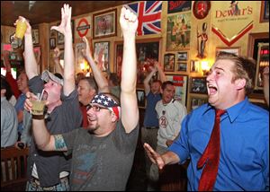Soccer fans in the Royal Mile bar in Des Moines celebrate after Landon Donovan's goal sent the U.S. into the second round.