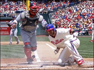 Philadelphia Phillies' Jayson Werth, right, scores safely as Cleveland Indians catcher Carlos Santana is late with the tag in the second inning .