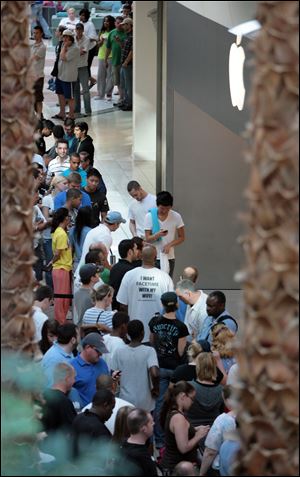 Customers line up to snag an iPhone 4 at the Apple Store in the Mall at Millenia in Orlando, Fla.