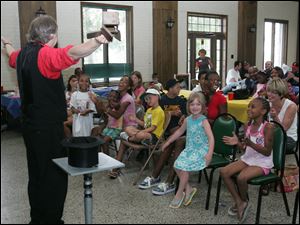 Magician Andrew Martin entertains at the Seventh Annual Yell & Tell: Stop Child Abuse Now rally at Walbridge Park in South Toledo.