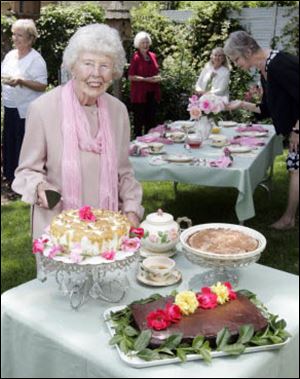 Florence Oberle, 95, serves afternoon tea in her garden at her home in Grand Rapids. Clockwise from upper left: Butterscotch Nut Torte, Apple Cake and Eggless Vinegar Chocolate Cake