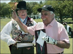 Jamie Farr rings the bell Wednesday after being named an honorary member of the American Guild of Town Criers by Town Crier Michael Lieber of Sylvanina, left.