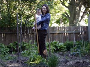 Jennifer Shafer and daughter Chloe in teh garden of tehir home in South Toledo.