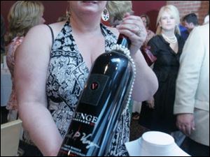 Bobbee Clawson holds a large bottle of wine that was up for auction at the Beach House fund-raising event.<br>
<img src=http://www.toledoblade.com/graphics/icons/photo.gif> <font color=red><b>NEW IMAGES:</b></font> <a href="/apps/pbcs.dll/gallery?Avis=TO&Dato=20100710&Kategori=COLUMNIST10&Lopenr=710009999&Ref=PH"> <b> Wine Benefits </b></a>