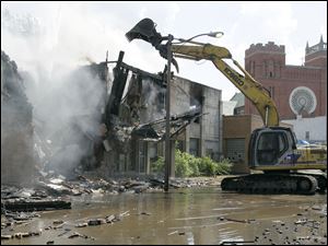 Demolition of the former Tate Funeral Service and an adjacent structure in the 1000 block of Broadway after a fire ripped through the vacant buildnig. The fire is being investigated as arson.